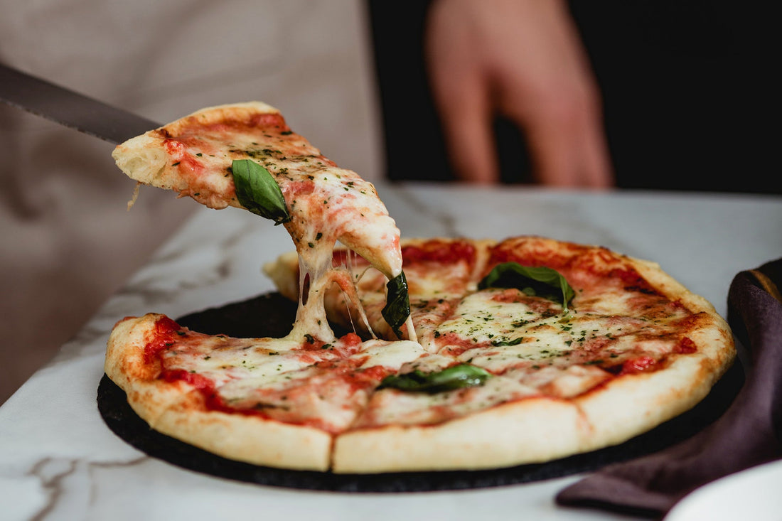 A Waiter Serving Neapolitan Pizza